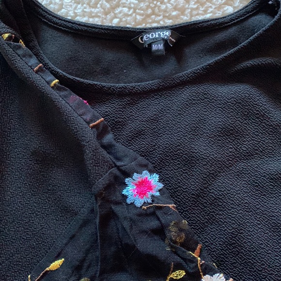 A medium sized shirt. Black with a flower lace sleeve. - Picture 2 of 2